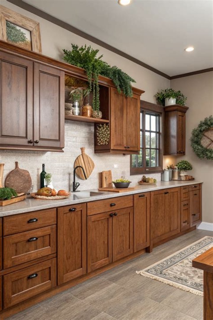 rich warm wood kitchen cabinets with neutral countertops and natural light in organic modern kitchen design